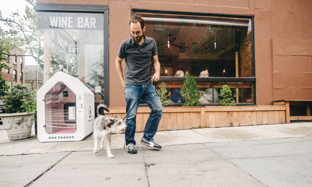 Man with dog stops at Dog Parker in Brooklyn, New York.