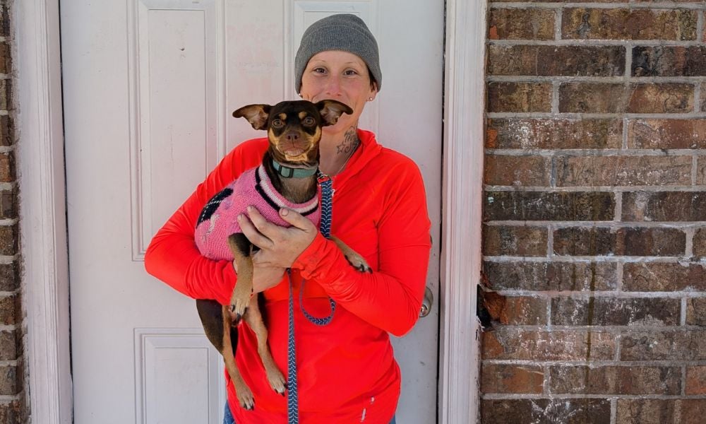 Woman holding small dog