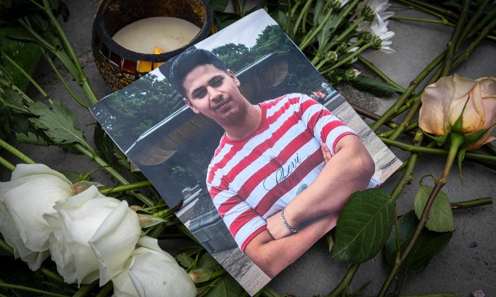 Photo of Romanch Mahajan memorial surrounded by flowers during a vigil held in his honor